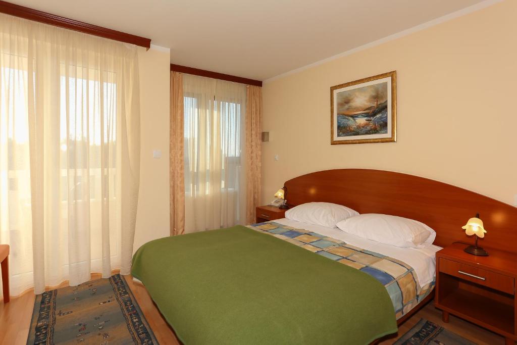 Posteľ alebo postele v izbe v ubytovaní Apartments and Rooms Astoria