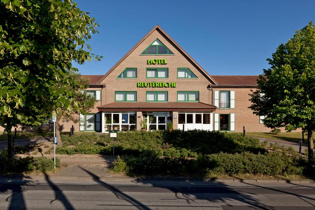 a building with a sign on the front of it at Hotel Reutereiche in Reuterstadt Stavenhagen