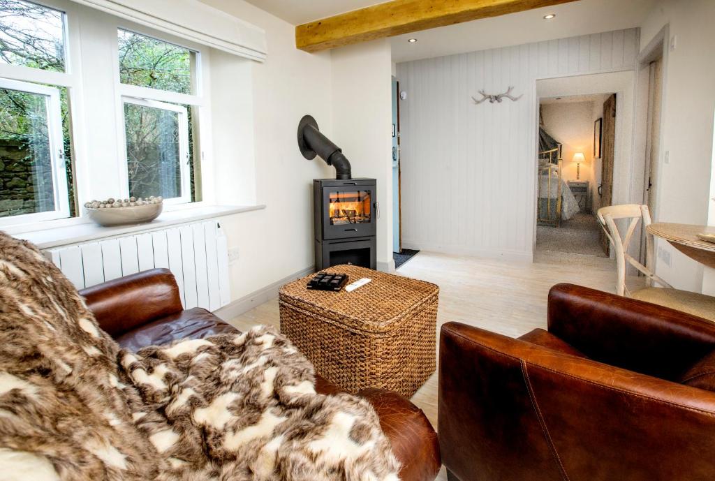 a living room with a couch and a fireplace at The Stables in Settle