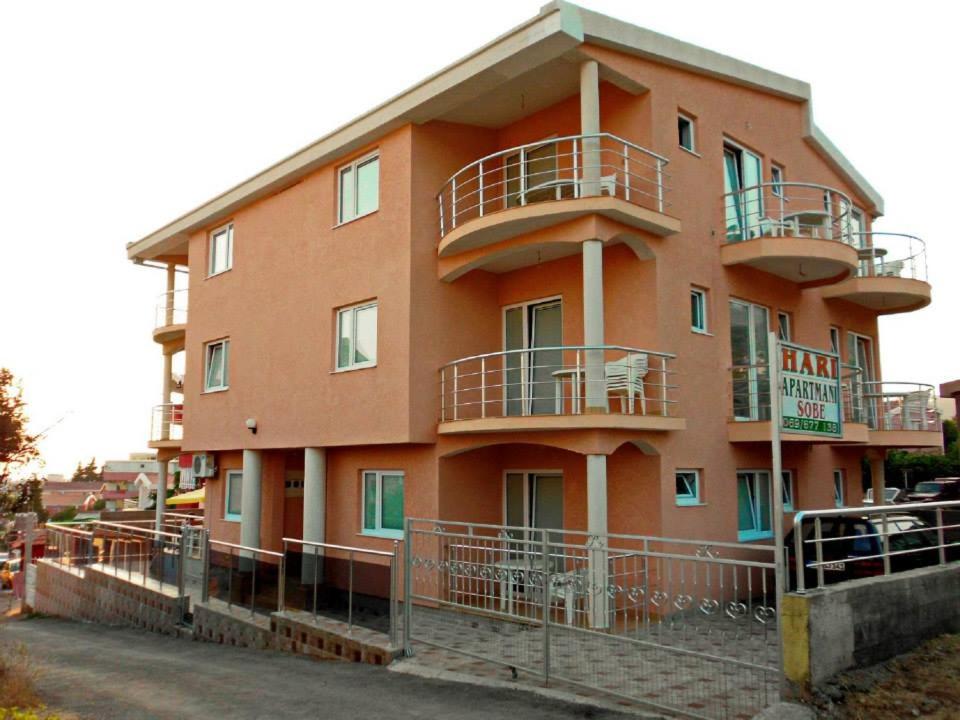 a orange building with balconies on the side of it at Apartmans Hari in Dobra Voda