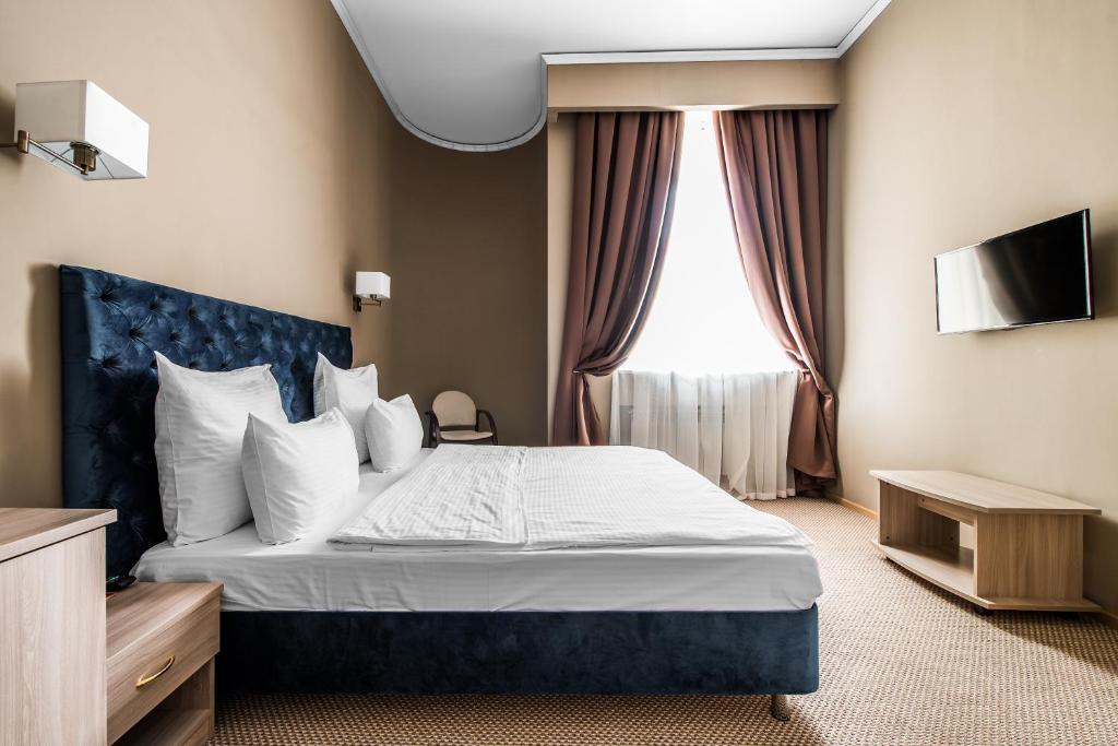 a hotel room with a bed and a window at Fortis Hotel Moscow Dubrovka in Moscow