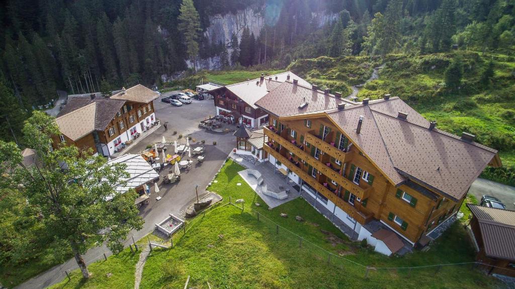 an aerial view of a large building in the mountains at Griesalp Hotels in Kiental