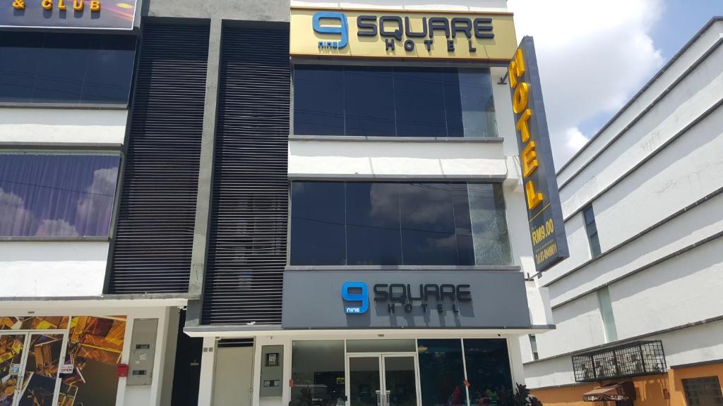 a store front of a building with a sign on it at 9 Square Hotel - Seri Kembangan in Seri Kembangan