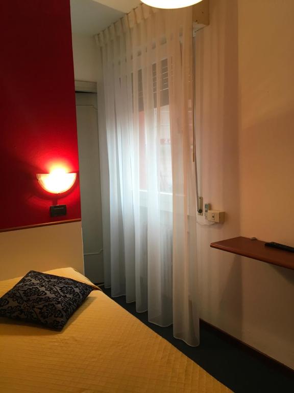 Postel nebo postele na pokoji v ubytování Hotel Cortina