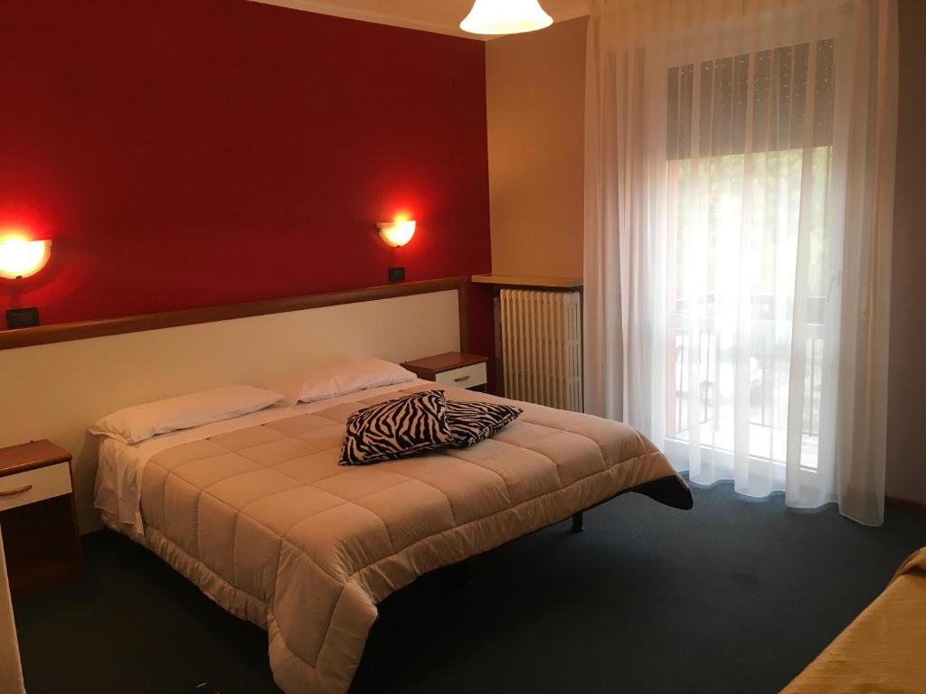 Postel nebo postele na pokoji v ubytování Hotel Cortina