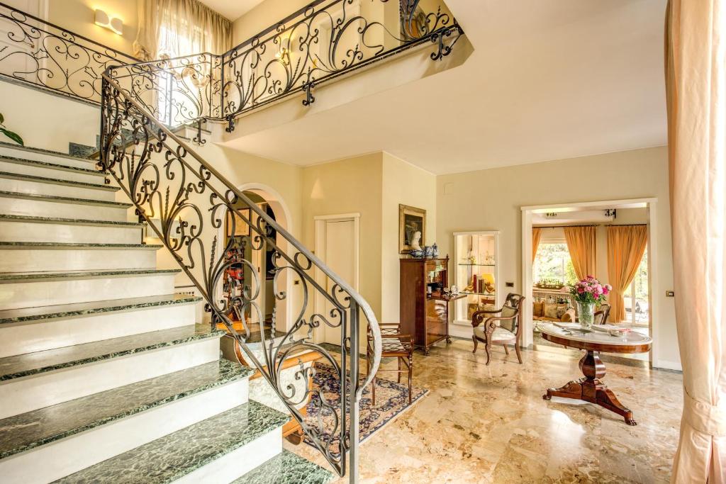 an ornate staircase in a home with aoyer at La Gaura Guest House in Casal Palocco