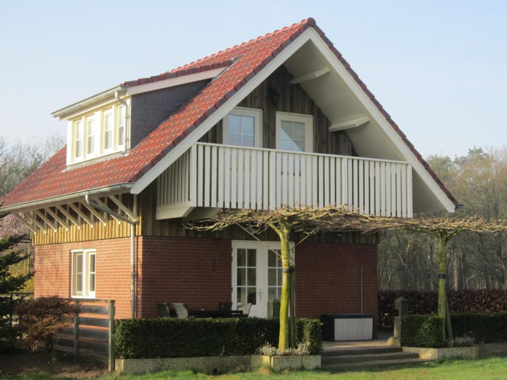 a house with a gambrel roof at Rural holiday home in Well with garden in Knikkerdorp
