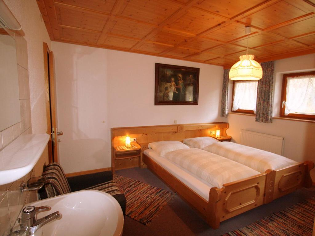 a bedroom with a bed and a sink at Apartment in St Gallenkirch near Ski Slopes in Sankt Gallenkirch