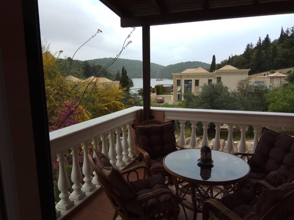 a balcony with chairs and a table and a view at Edem Studios in Syvota