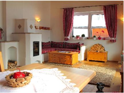 a living room with a table and a couch at Apartment Großvenedigerblick in Neukirchen am Großvenediger