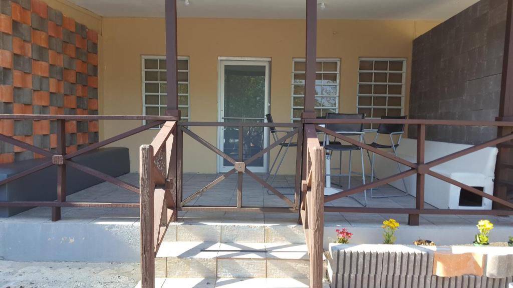 a wooden gate to a porch with a table and chairs at Vista Azul in Aguada