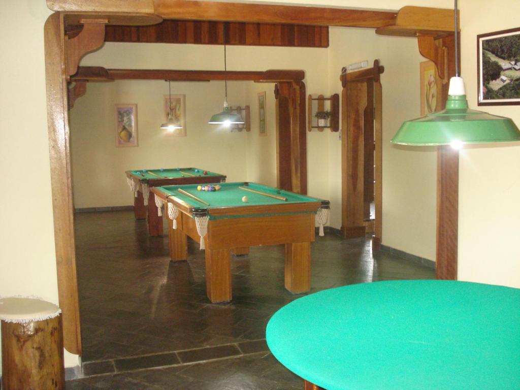 Habitación con mesas de billar y una mesa verde. en Pousada Recanto Águas Vivas en Turvo dos Góis