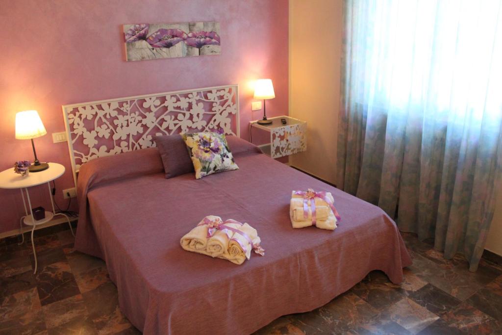 Postel nebo postele na pokoji v ubytování Affittacamere Casa Mac & Rose