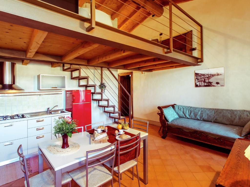 a kitchen and living room with a couch and a table at Belvilla by OYO Bilo Grande della Cascina in Salò