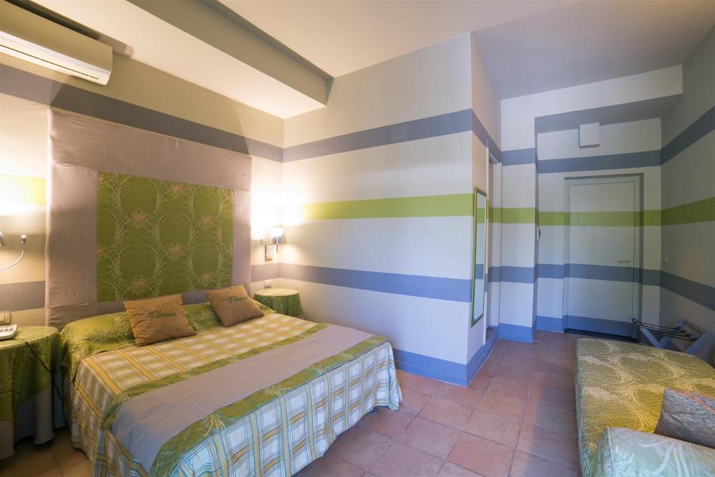 Cama ou camas em um quarto em Hotel Villamare