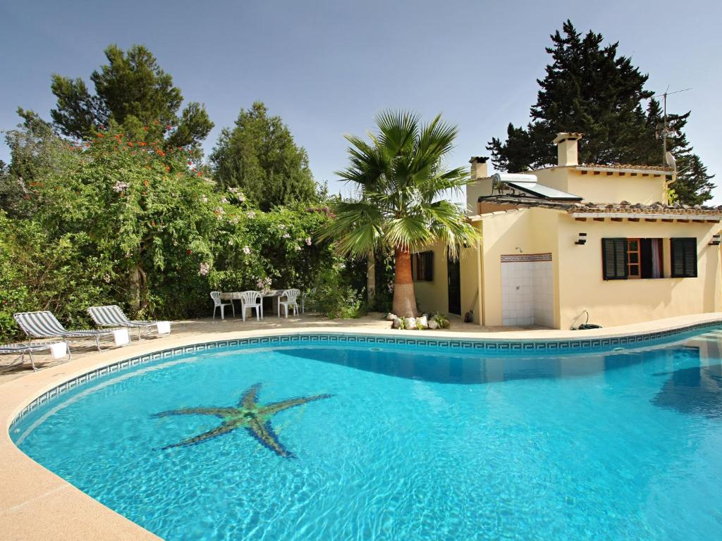 a swimming pool with a starfish in front of a house at Belvilla by OYO Ca Na Patufa in Alcudia