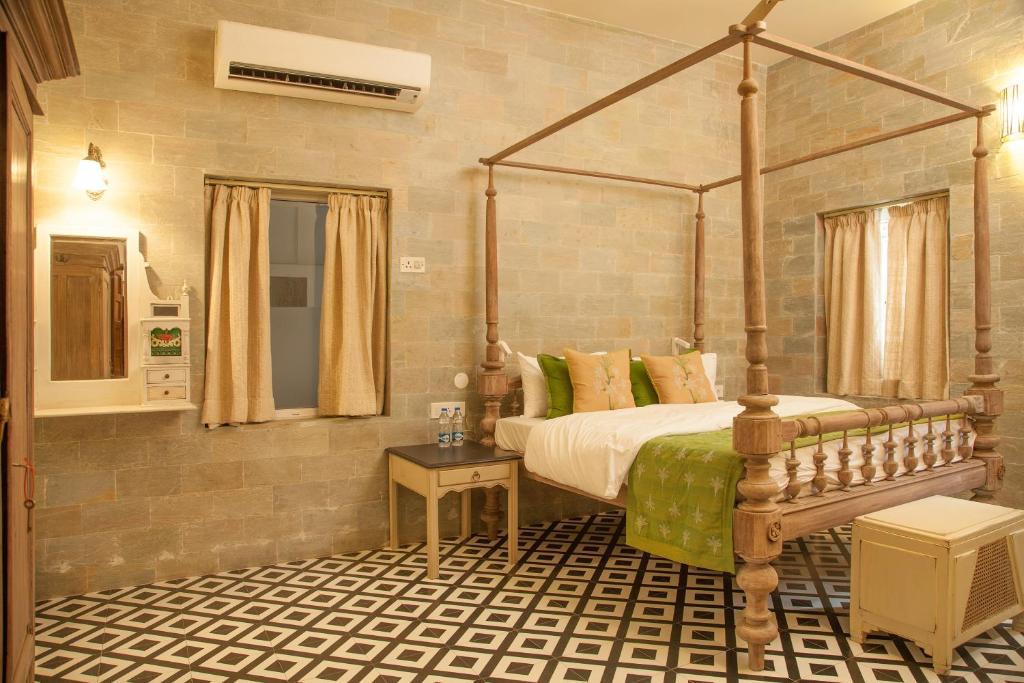a bedroom with a canopy bed in a room at The Ivy House in Kolkata