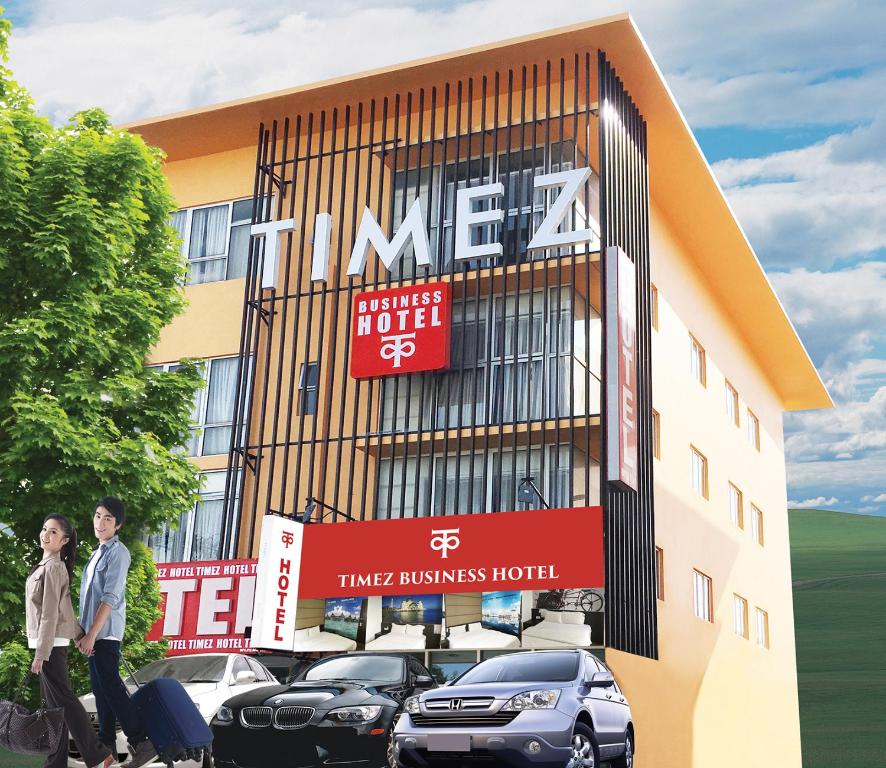 a building with cars parked in front of it at Timez Business Hotel in Kuala Lumpur