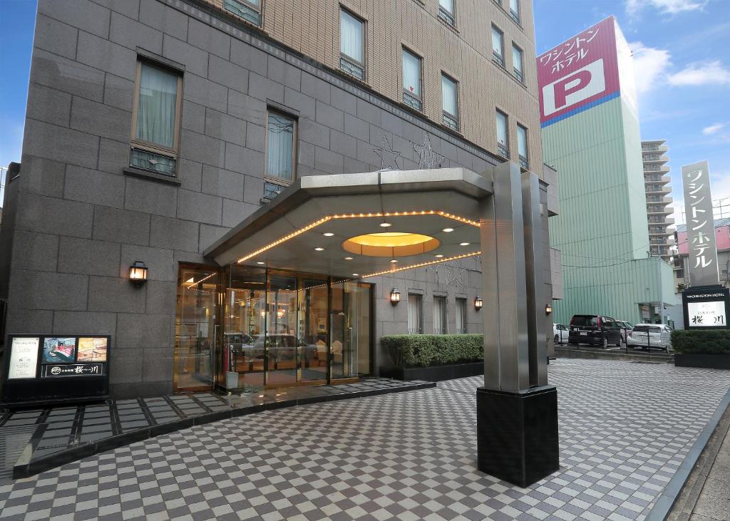 a building with a large entrance to a building at Sasebo Washington Hotel in Sasebo