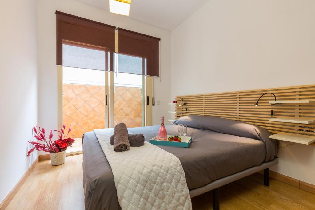 a bedroom with a bed with a tray of food on it at Matarolux 11 in Mataró