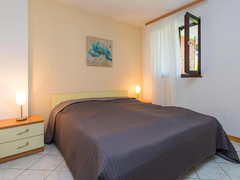 a bedroom with a bed and a dresser and a mirror at Apartments Špadići in Poreč