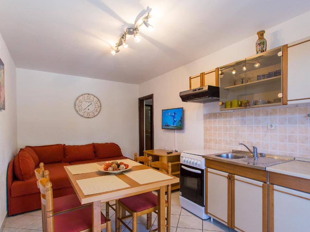 a kitchen and living room with a couch and a table at Apartments Špadići in Poreč