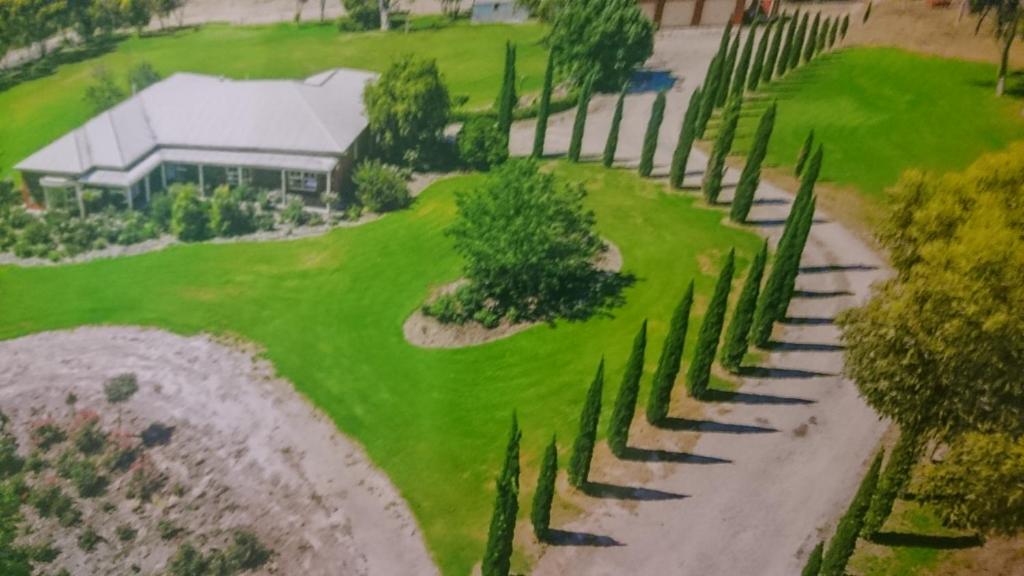 an overhead view of a golf course with cypress trees at Gaerwood B&B in Keith