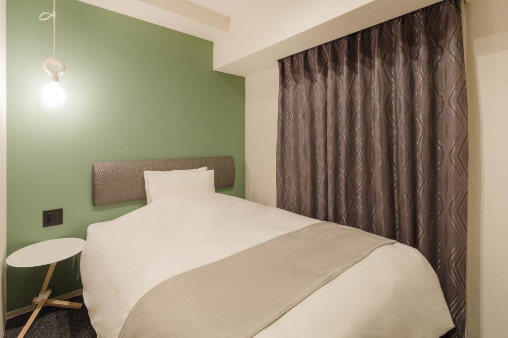 Postel nebo postele na pokoji v ubytování Hotel M's Est Shijo Karasuma