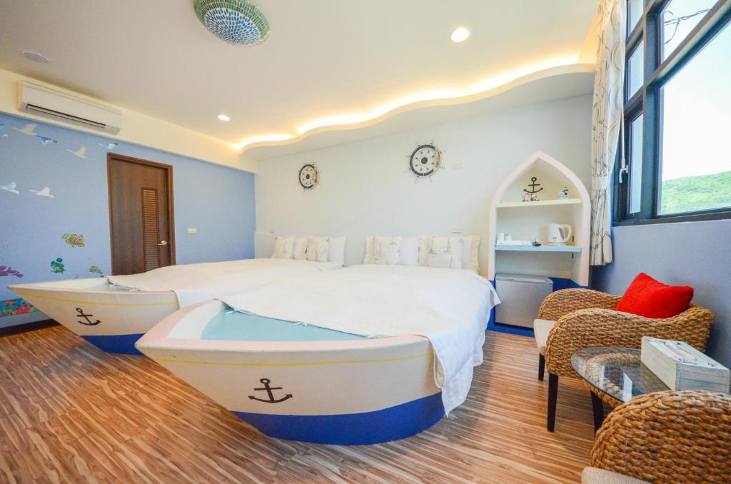 a bedroom with a bed with a boat on it at Ciao House B&B in Kenting