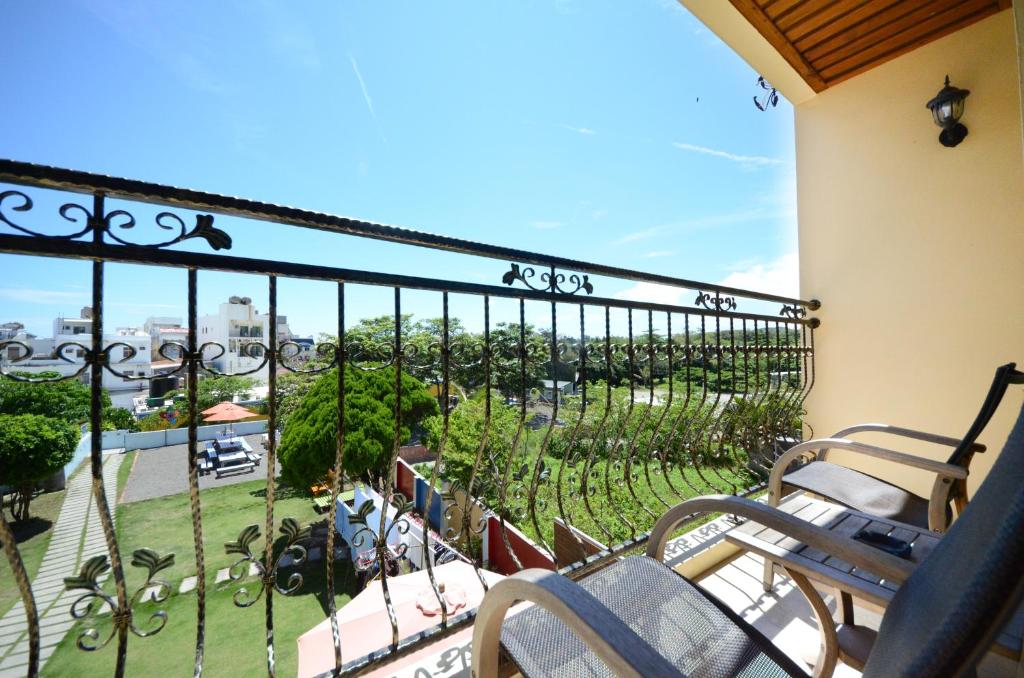 a balcony with chairs and a view of a park at Ciao House B&B in Kenting