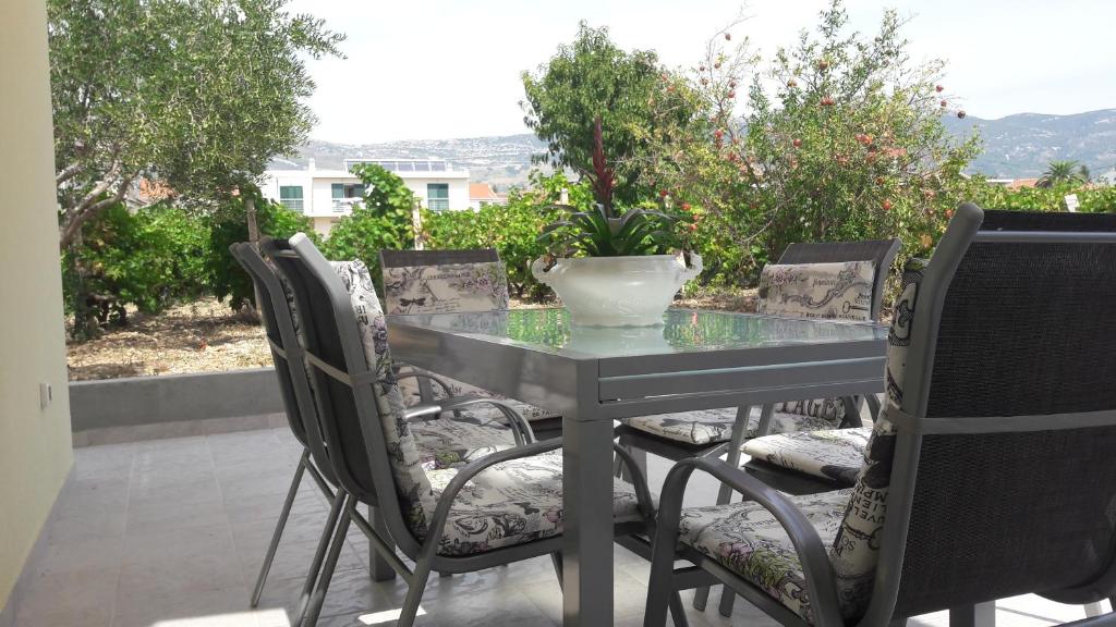 a glass table and chairs on a patio at Apartment Lebedina in Kaštela