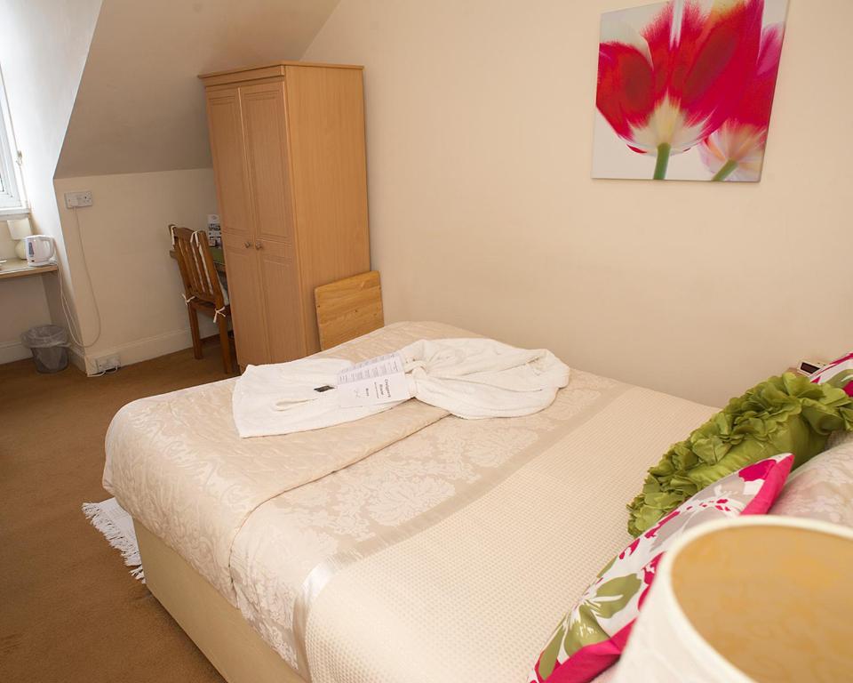 a bedroom with a bed with a shirt on it at Craig Park House in Airdrie