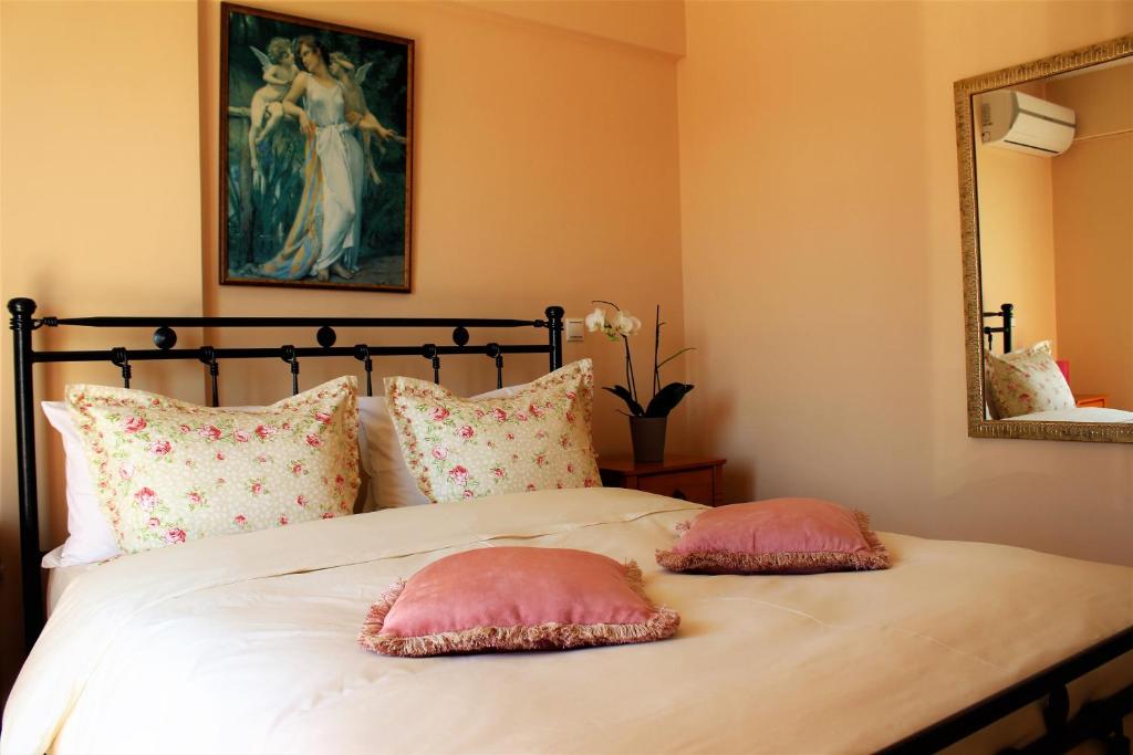 two pink pillows on a bed in a bedroom at Helen's Sounio Apartments in Sounio
