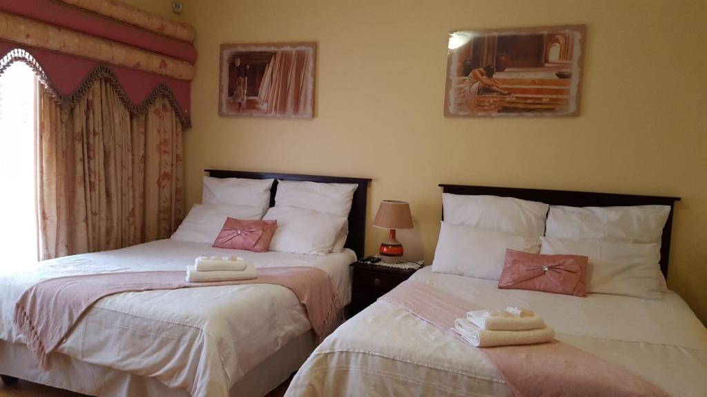 two beds sitting next to each other in a bedroom at Sleepwell in East London