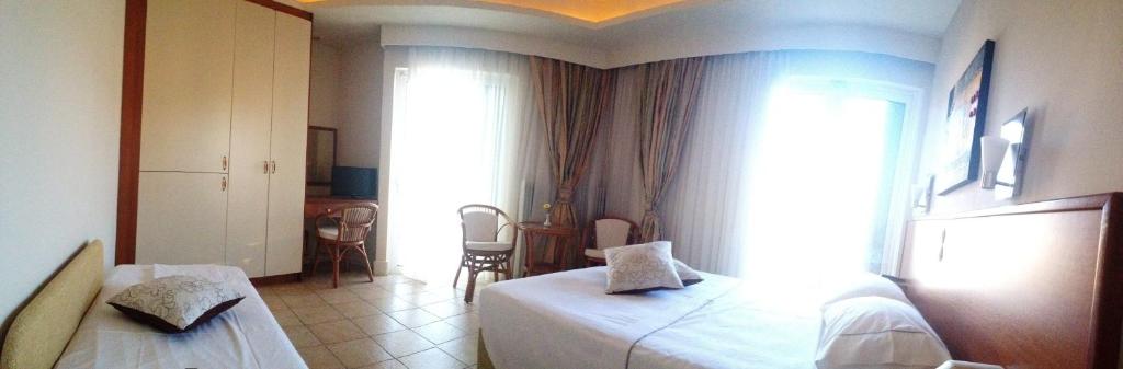 Postel nebo postele na pokoji v ubytování Souris Hotel