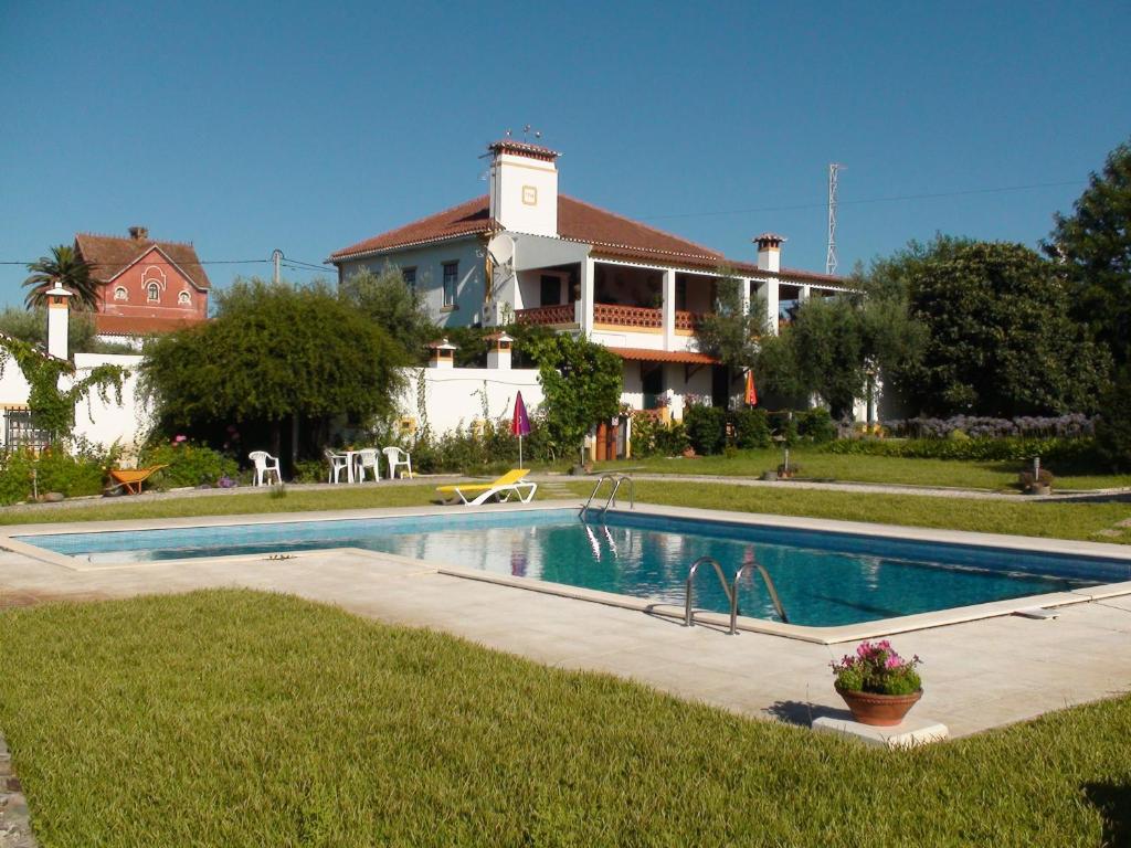 a swimming pool in front of a house at A Tejada in Ortiga