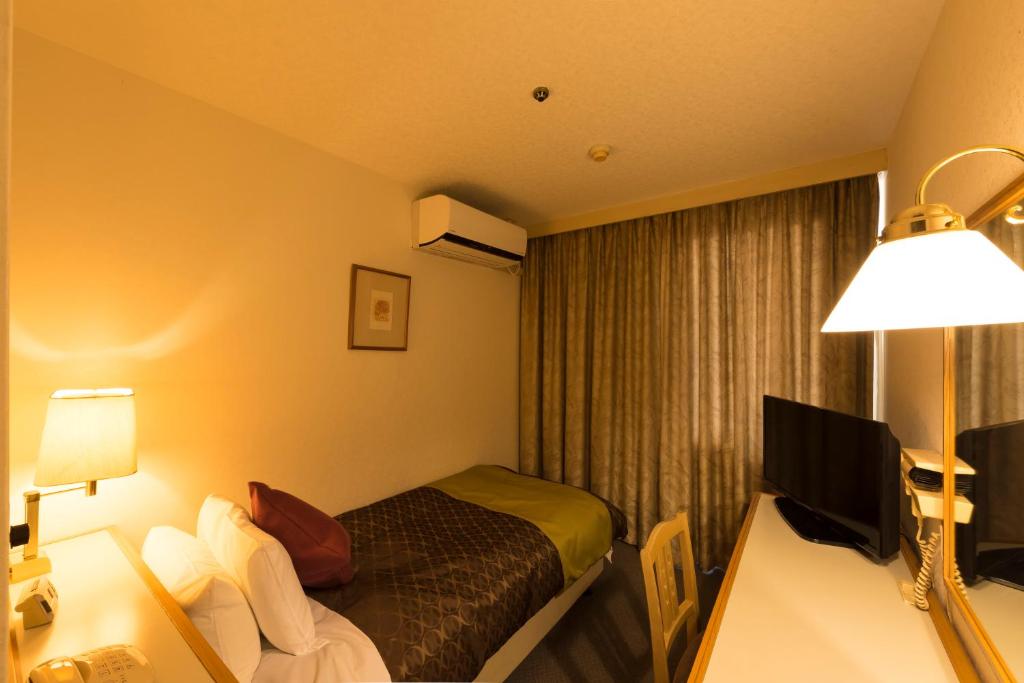 Postel nebo postele na pokoji v ubytování Sky Hotel Uozu