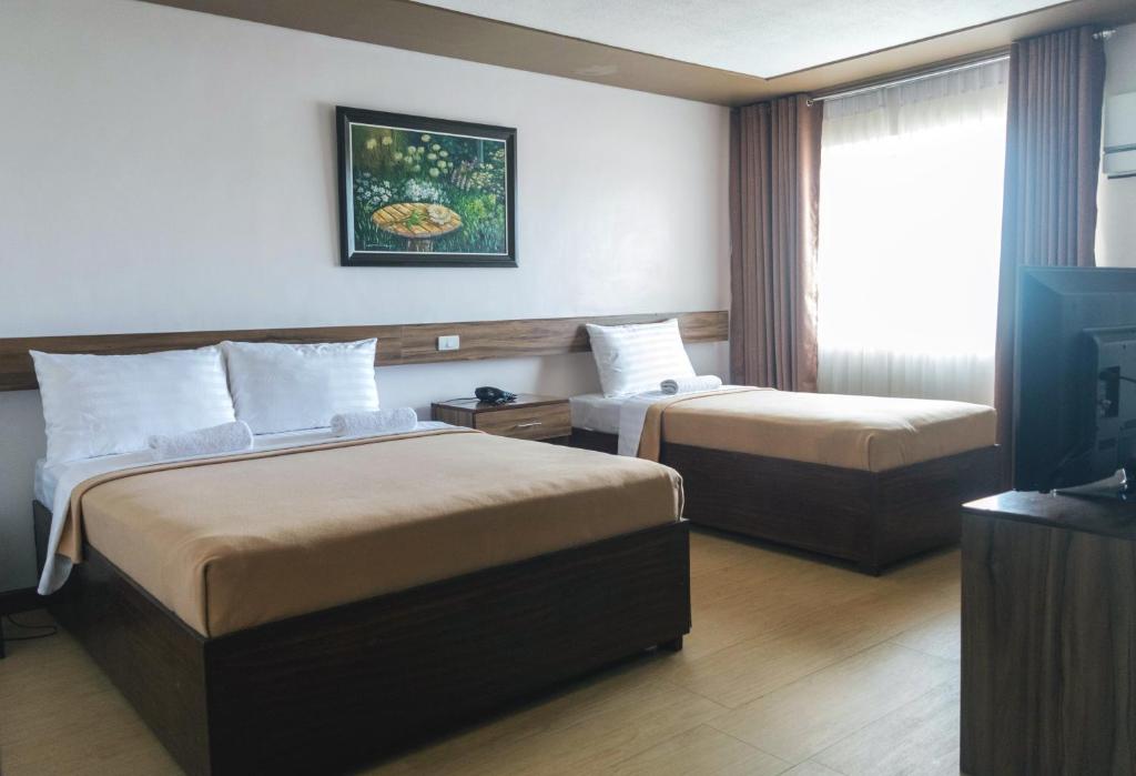 Postel nebo postele na pokoji v ubytování Leope Hotel