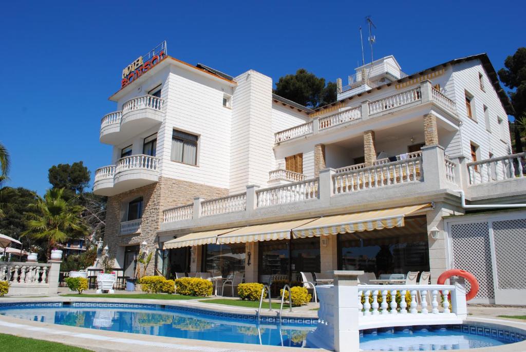 - un grand bâtiment blanc avec une piscine en face dans l'établissement Hotel Bonsol, à Lloret de Mar