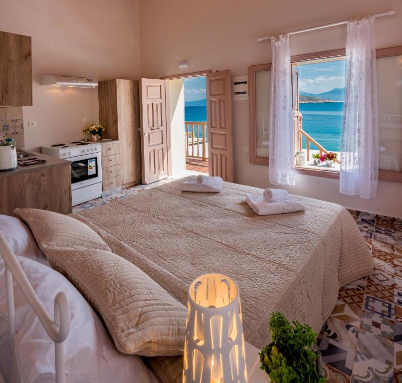 a bedroom with a large bed with a view of the ocean at Spitakia in Halki