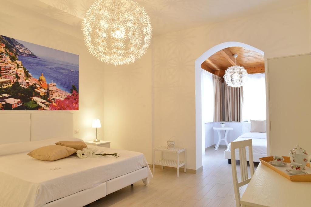 a bedroom with a bed and a chandelier at Villa Miriam in Gragnano