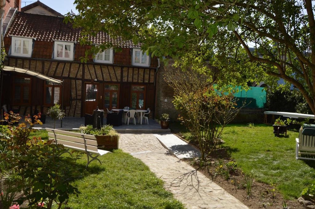 a house with a garden with a bench in the yard at Au Coeur d'Amiens in Amiens