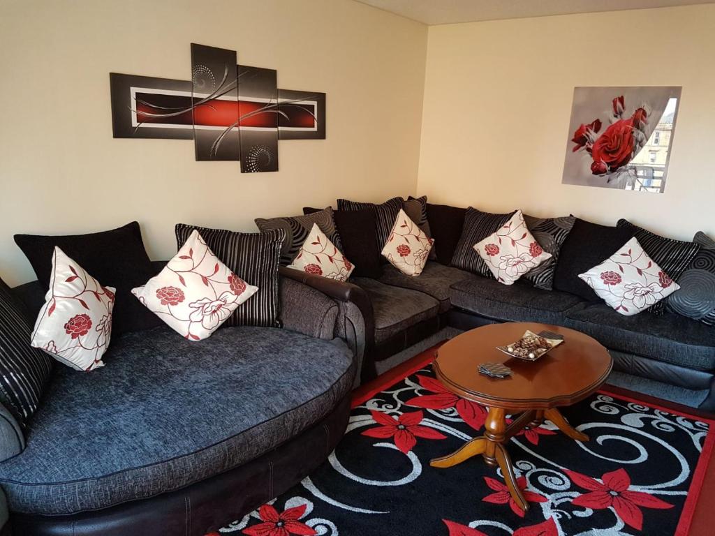 a living room with two couches and a table at Edinburgh City Deluxe Apartment in Edinburgh