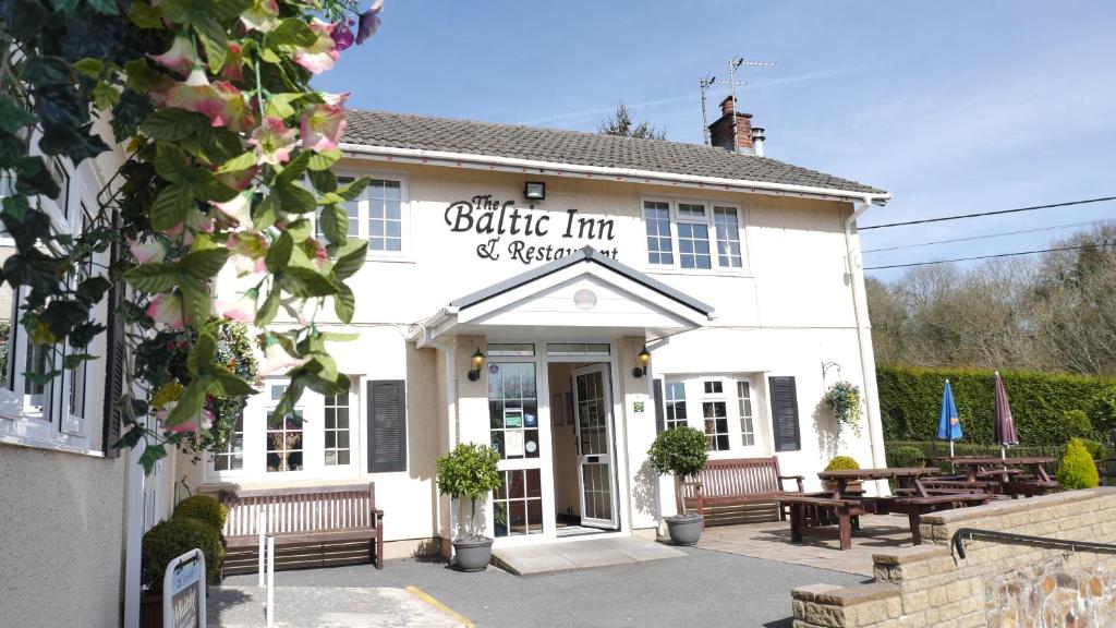 a white building with a sign on the front of it at The Baltic Inn & Restaurant in Pont Yates