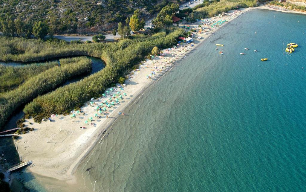 an aerial view of a beach with chairs and umbrellas at Bayview Apartments in Agios Nikolaos