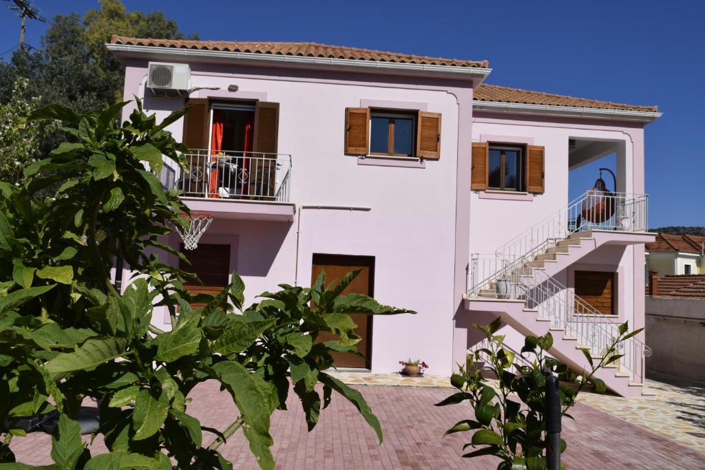 a large white house with stairs and windows at Iris Apartments Ithaca in Vathi