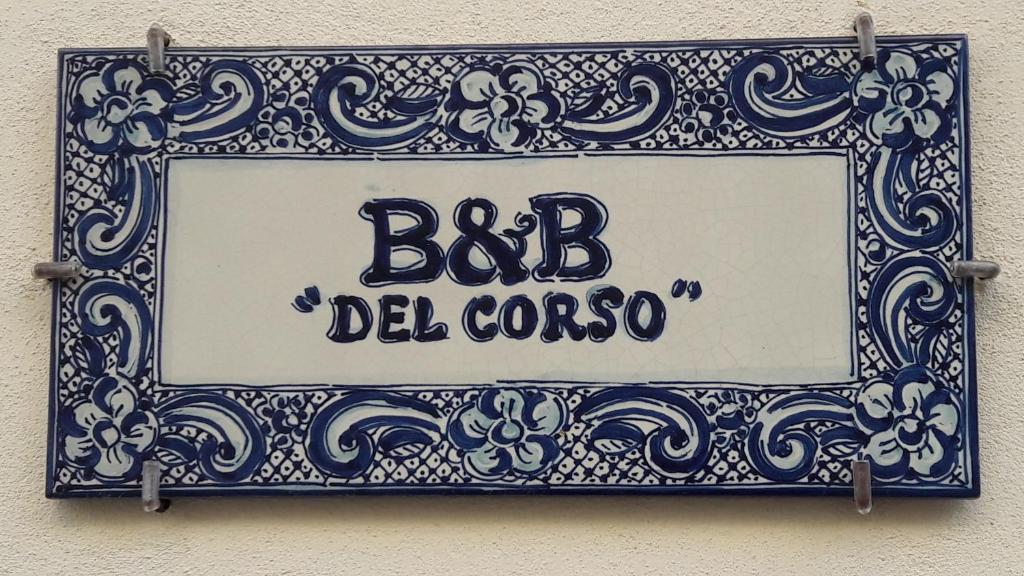 a blue and white sign on the side of a building at B&B Del Corso in Mazara del Vallo