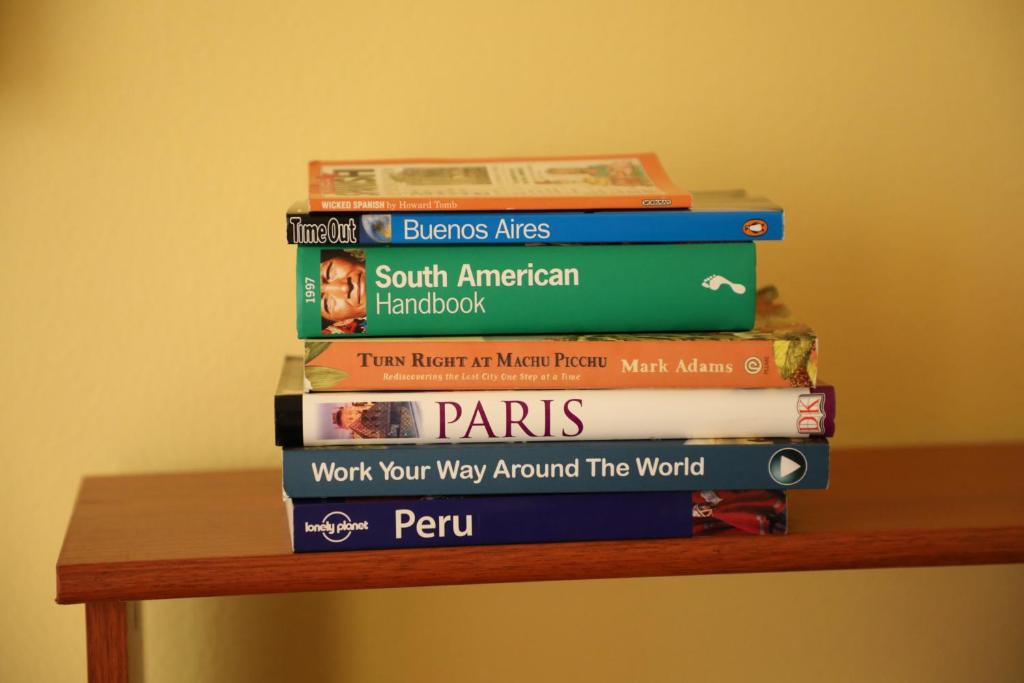 a stack of books sitting on top of a table at Edificio Juana Chorrillos in Lima