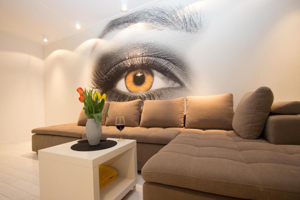 a wall with a picture of an eye on it at Lenzo Apartments in Krakow