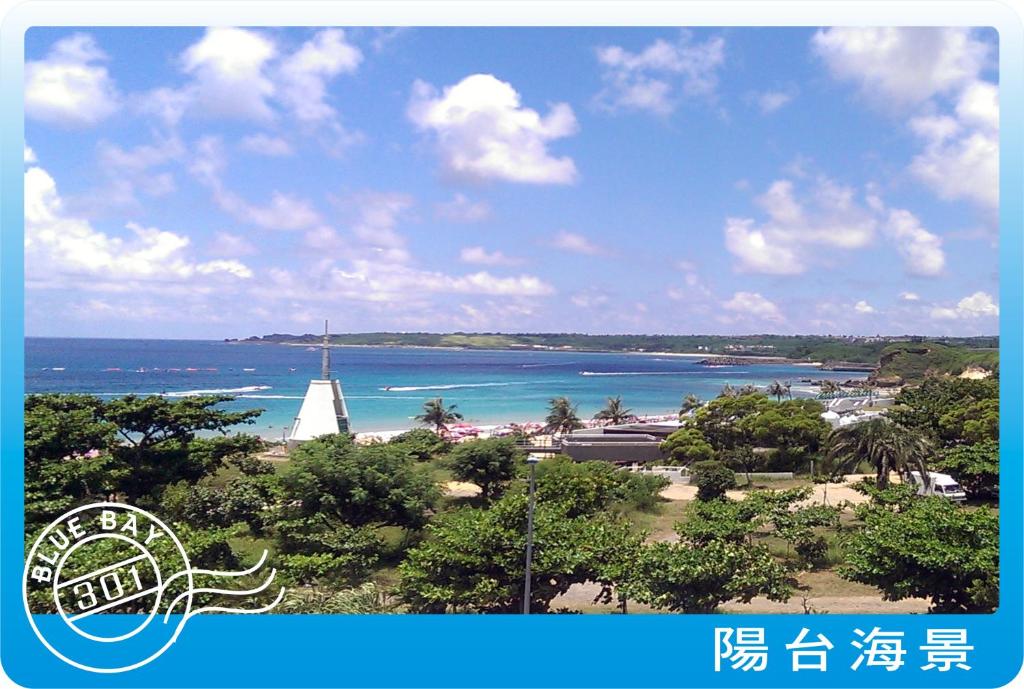a view of a beach with a sail boat in the water at Kenting Blue Bay Inn in Nanwan